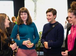 Foru young scholars talking at post-event drinks