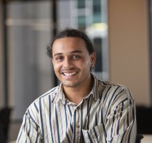 Headshot of male student smiling into camera.