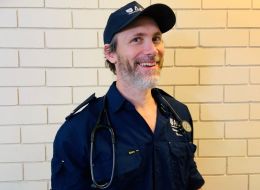 Andrew McLeod-Warner, ACU scholar. Man in paramedic uniform smiling.