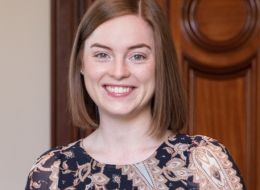 Hannah Webb, ISSI fellow. Smiling woman with shoulder length red hair.