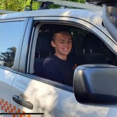 Jessica Britton, ACU scholar, smiling in SES vehicle.