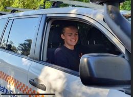 Jessica Britton, ACU scholar, smiling in SES vehicle.