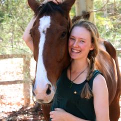 Josette Fretton, Murdoch University scholar. Young woman smiling with her arm wrapped around a brown and white horse.