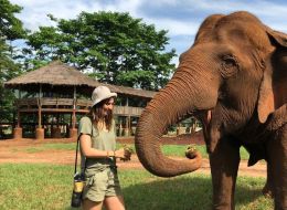 Kayla Rowe, Murdoch University Scholar. Young woman standing next to an Asian Elephant.
