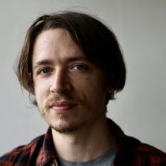 Shane Wiechnik, ISSI fellow. Headshot of man with brown hair and eyes wearing a flannel shirt. 