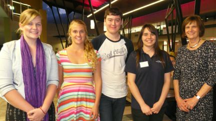 Four young students standing with GAF CEO Janet Hirst