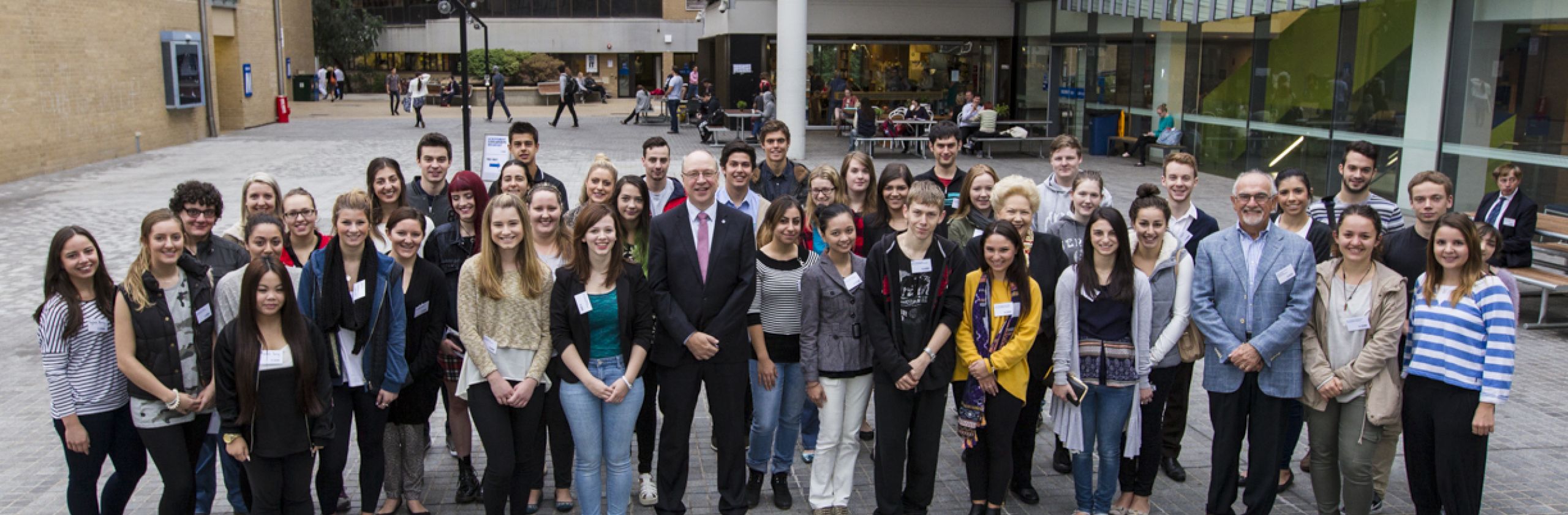 A large group of GAF scholars standing on a university campus