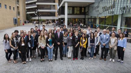 A large group of GAF scholars standing on a university campus
