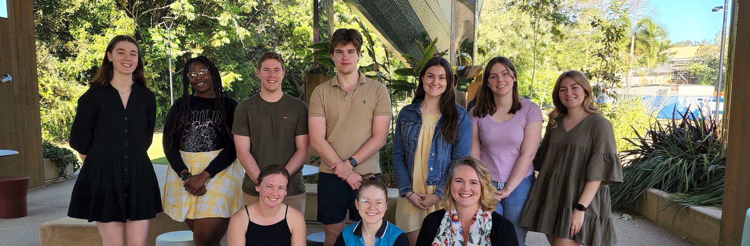 A large group of James Cook University Scholars smiling, standing outside on a sunny day. 