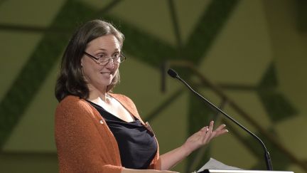 Woman standing at a lectern