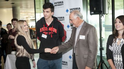 Female student shaking hands with the Chancellor at Victoria University