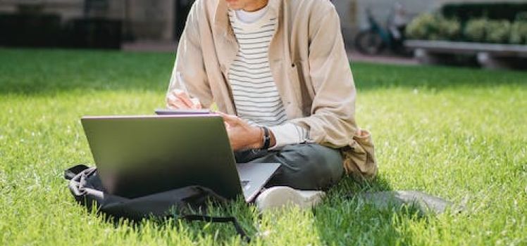 Student on laptop outside 