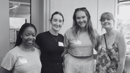 4 young women smiling at camera.