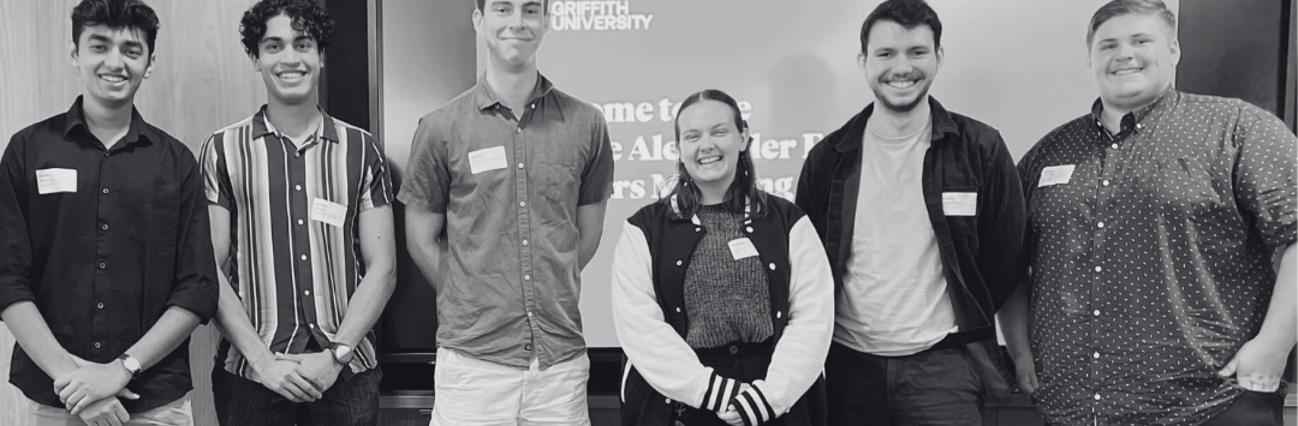Scholars smiling looking at camera.
