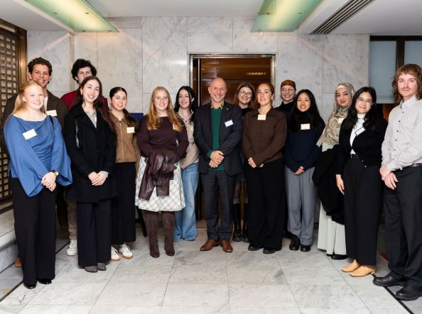 Row of GAF staff, scholars and alumni smiling at camera.