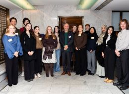 Row of GAF staff, scholars and alumni smiling at camera.